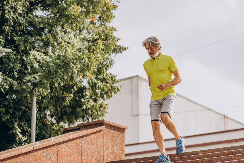 Middle aged man jogging down and upstairs